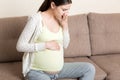 Pregnancy Morning Sickness. Pregnant Woman Having Nausea Feeling Bad in Sofa at the Home Royalty Free Stock Photo