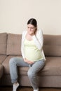 Pregnancy Morning Sickness. Pregnant Woman Having Nausea Feeling Bad in Sofa at the Home Royalty Free Stock Photo