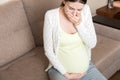 Pregnancy Morning Sickness. Pregnant Woman Having Nausea Feeling Bad in Sofa at the Home Royalty Free Stock Photo