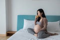Pregnancy, motherhood and expectation concept - happy asian pregnant woman drink orange juice Royalty Free Stock Photo