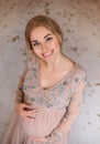 Lovely young pregnant woman in a beautiful dress Royalty Free Stock Photo