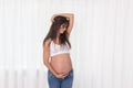 Pregnancy, motherhood, people and expectation concept - close up of happy pregnant woman with big belly at window Royalty Free Stock Photo