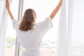 Pregnancy, motherhood, people and expectation concept - close up of happy pregnant woman opening window curtains