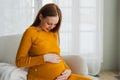 Pregnancy motherhood people expectation future. Pregnant woman with big belly sitting on chair near window at home. Girl Royalty Free Stock Photo