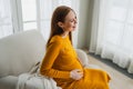 Pregnancy motherhood people expectation future. Pregnant woman with big belly sitting on chair near window at home. Girl Royalty Free Stock Photo