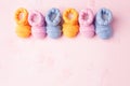 Pregnancy motherhood perenthood concept, Three pairs of baby booties on pink background, baby shower, first birthday party banner Royalty Free Stock Photo