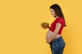 Pregnancy Nutrition. Beautiful Pregnant Woman Holding Bowl With Vegetable Salad