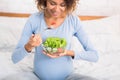 Pregnancy and nutrition. Expectant woman eating fresh salad