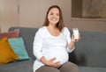 Pregnancy Nutrition. Portrait Of Young Smiling Pregnant Woman Holding Glass Of Milk