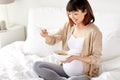 Happy pregnant woman eating cereal flakes at home Royalty Free Stock Photo