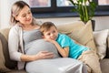 Happy pregnant mother and son hugging at home Royalty Free Stock Photo