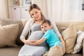 Happy pregnant mother and son hugging at home Royalty Free Stock Photo