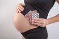 Pregnancy, people and health care concept - close up of pregnant woman. vitamins and minerals for pregnant women. Taking Royalty Free Stock Photo