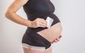 Pregnancy, people and health care concept - close up of pregnant woman. vitamins and minerals for pregnant women. Taking Royalty Free Stock Photo