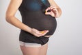 Pregnancy, people and health care concept - close up of pregnant woman. vitamins and minerals for pregnant women. Taking Royalty Free Stock Photo