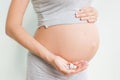 Pregnancy, people and health care concept - close up of pregnant woman. vitamins and minerals for pregnant women. Taking Royalty Free Stock Photo