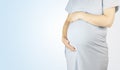 Pregnancy. Pregnant woman on a blue background with copy space. Royalty Free Stock Photo