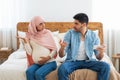 Pregnancy and relationship problems. Muslim couple arguing at home, expectant arab lady and her husband quarreling Royalty Free Stock Photo