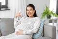 pregnant woman with water in glass bottle at home Royalty Free Stock Photo