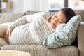 pregnant asian woman sleeping on sofa at home Royalty Free Stock Photo