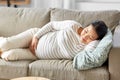 pregnant asian woman sleeping on sofa at home Royalty Free Stock Photo