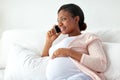 Happy pregnant woman calling on smartphone at home Royalty Free Stock Photo