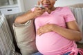 Pregnant woman using voice recorder on smartphone Royalty Free Stock Photo