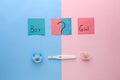 Pregnancy test and papers with words BOY, GIRL and question mark on color background Royalty Free Stock Photo