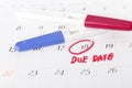 Pregnancy test with positive result lying on calendar background Royalty Free Stock Photo