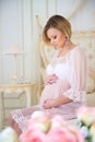 Pregnancy and waiting for baby. Pregnant mother sitting on a bed of roses