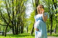 Pregnancy walking woman. Baby belly. Pregnant walk nature. Happy maternity mother in summer park. Active pregnancy. Royalty Free Stock Photo