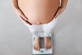 Pregnancy Weight Control. Pregnant Woman On Scale
