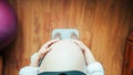 Pregnancy weight gain woman. Happy pregnant woman standing on weight scales. Therapy, healthcare, motherhood concept. Royalty Free Stock Photo