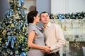 Pregnancy, winter holidays and people concept - happy pregnant wife with husband at home at christmas. Young family Royalty Free Stock Photo