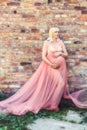 Pregnancy woman in a pink dress