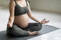 Pregnancy Yoga. Cropped Shot Of Young Pregnant Woman Meditating At Home Royalty Free Stock Photo