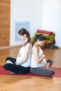 Pregnancy Yoga, Fitness concept. Portrait of two attractive young pregnant yoga models working out indoor