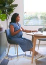 Pregnant African American Woman Using Laptop At Table Working From Home Royalty Free Stock Photo