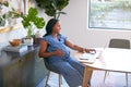 Pregnant African American Woman Using Laptop At Table Working From Home Royalty Free Stock Photo