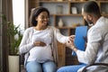 Pregnant african american woman visiting doctor at private clinic Royalty Free Stock Photo