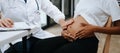 Pregnant african woman has appointment with doctor at clinic. Male gynaecologist OB GYN medic specialist with stethoscope listens