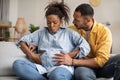 Pregnant African Woman Having Labor Pains, Husband Hugging Her Indoors Royalty Free Stock Photo