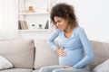 Pregnant afro woman having contraction at home Royalty Free Stock Photo