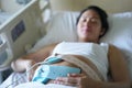 Pregnant Asian Chinese Woman lying on the hospital bed Royalty Free Stock Photo