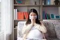 Pregnant asian female wearing mask mouth, She sitting on sofa and feels sick and coughing. Pregnant woman belly closeup protective
