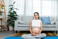 pregnant Asian mother meditating. and a very pregnant woman ready to bear her children. Meditate to relax and de-stress.