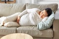 pregnant asian woman sleeping on sofa at home Royalty Free Stock Photo