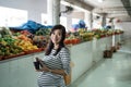 Pregnant asian woman take money out of his wallet to pay for goods Royalty Free Stock Photo