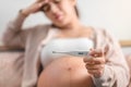 Pregnant asian woman used digital thermometer on bed at morning, Sick female with high fever, Selective focus, Healthy and Royalty Free Stock Photo