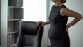 Pregnant bank worker feeling pain in loins, trimester problems, health care